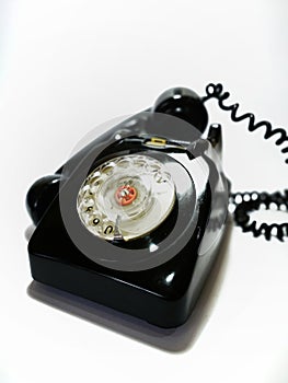 A vintage and antique telephone with white background. photo